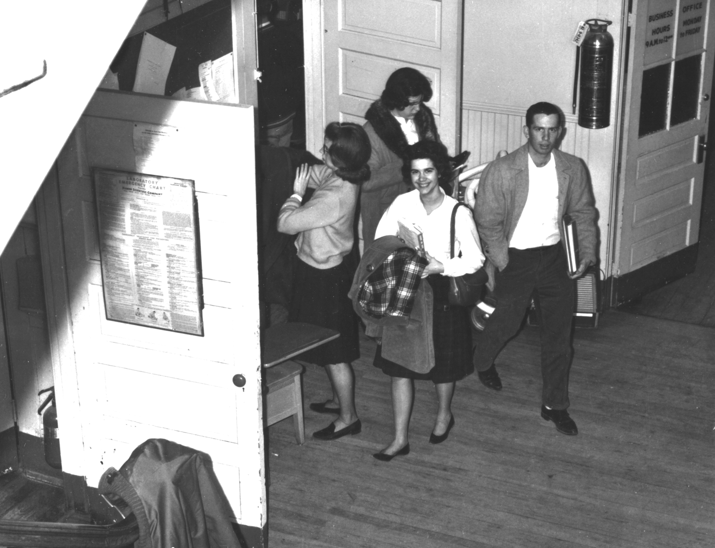 Marianne Torregrossa, Kathy Parnell, Anne Walker, [and] Jim Pracht getting out of 5 o'clock math class, Bailey's Crossroads.  